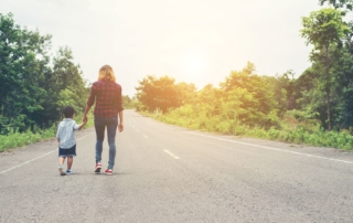 mother and son walking hand in hand